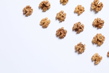 Walnuts on white background, top view