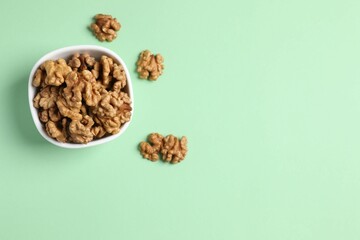 Walnuts on color background, top view