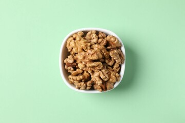 Walnuts on color background, top view
