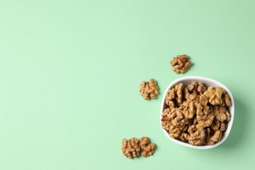 Walnuts on color background, top view
