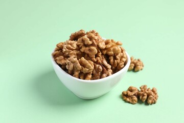 Walnuts on color background, top view