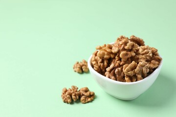Walnuts on color background, top view
