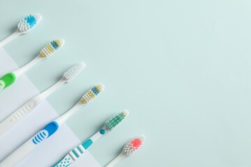 Various toothbrushes on a colored background. Concept of tooth treatment and dental care