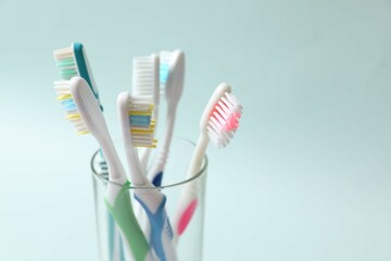 Various toothbrushes on a colored background. Concept of tooth treatment and dental care