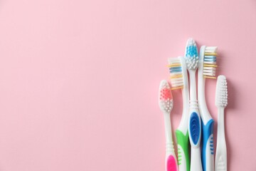 Various toothbrushes on a colored background. Concept of tooth treatment and dental care