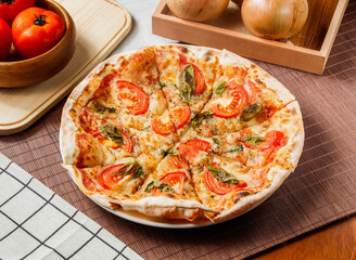 Classic Margherita Pizza topping with tomato and basil leaf served in plate isolated on table side view of taiwan fast food