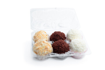 Delicious truffles with variety sprinkling in plastik pack isolated on white