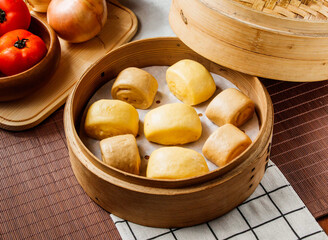 Steamed Mantou Buns in Bamboo Steamer isolated on napkin side view on table taiwan food