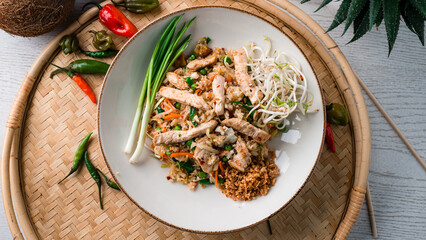Pilaf with pork, carrots, onions, green peas and green sprouts.