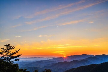 Obraz premium A serene landscape with the sun setting behind the mountains in the distance, ideal for use as a background or to evoke a sense of calm