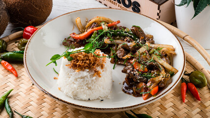 Dinner stewed beef, eggplant, onion, sweet pepper, green beans in teriyaki sauce with rice and herbs.