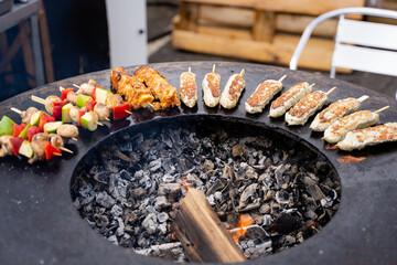 Experience a Sizzling Barbecue Feast featuring Grilled Skewers alongside flavorful Sausages and more