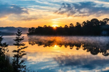 Fototapeta premium A serene scene with the sun dipping below the water's surface, creating a warm glow on the lake