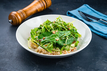 Fresh salad with quinoa, zucchini, cheese, arugula, spinach, parsley and pine nuts.
