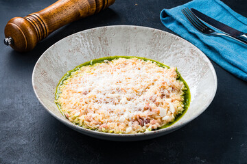 Italian lunch risotto with parmesan, Parma ham and sauce.