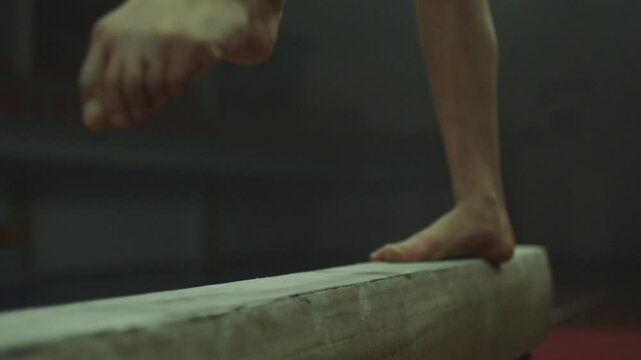 Feet of a Gymnast in red practicing on balance beam