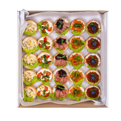 lunch set box. tartlets with nuts, quail eggs, ham, red fish, caviar and lettuce leaves on curd cream are beautifully packed and ready to eat. delivery menu