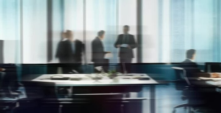 Blurred in motion diverse team of business people in a light and modern office building, zoom in timelaps, looping blurred animated background