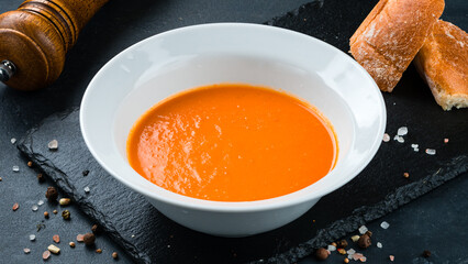 Carrot cream soup with bread and spices.