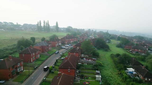 Aerial video provides an overview of Dewsbury Moore Council estate in the UK, highlighting red-brick housing and the industrial Yorkshire