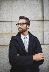 Thinking, business and man in city, arms crossed and commute with fashion, solution and idea. Person, employee or consultant with glasses for clear vision, calm or professional with corporate clothes