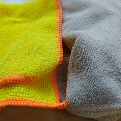 Microfiber сleaning сloth, isolated, close-up. Two dry multicolored microfiber cloths, yellow and gray, texture