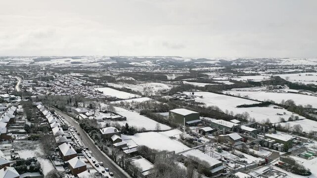 Aerial Drone Video Footage showing a snowy landscape in a suburban UK town.