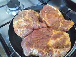 Pork with sauce on a frying pan 