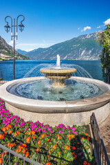 A fountain on the shores of Lake Garda in Limone Sul Garda town, Italy, Europe.