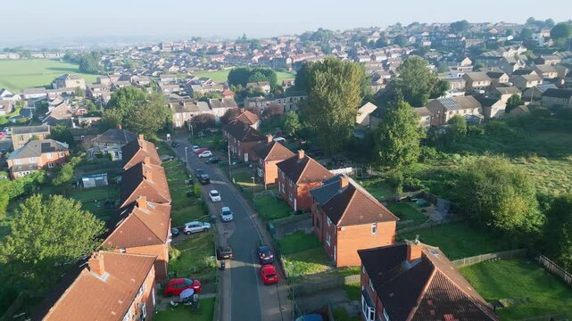 Aerial video provides an overview of Dewsbury Moore Council estate in the UK, highlighting red-brick housing and the industrial Yorkshire