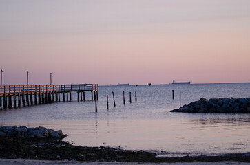 Purple sunset on the Chesapeake bay overlooking the fishing pier and breakwater