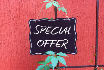Special Offer symbol. Concept word Special Offer on black chalk background. Beautiful red...