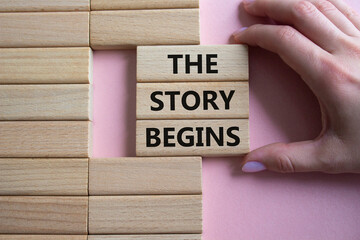 The Store Begins symbol. Concept words The Store Begins on wooden blocks. Businessman hand....