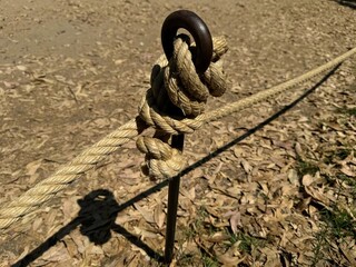 Thick rope on iron forming a knot as part of a rope fence.