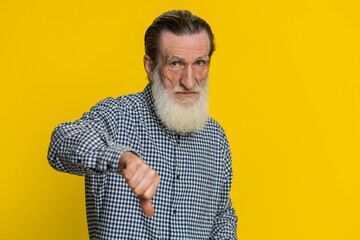 Dislike. Upset unhappy senior man showing thumbs down sign gesture, expressing discontent,...