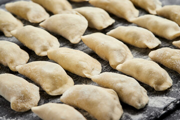 Freshly prepared homemade dumplings ready for cooking, showcasing traditional culinary skills