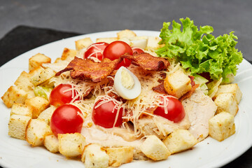 Fresh Caesar salad with cherry tomatoes, crispy bacon, and parmesan cheese, perfect for a light meal