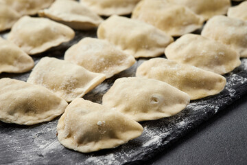Freshly prepared homemade dumplings ready for cooking, showcasing traditional culinary skills
