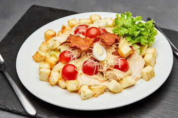 Fresh Caesar salad with cherry tomatoes, crispy bacon, and parmesan cheese, perfect for a light meal