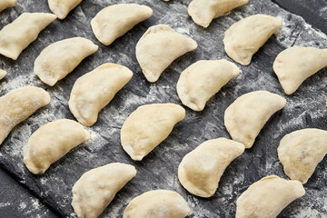 Freshly prepared homemade dumplings ready for cooking, showcasing traditional culinary skills
