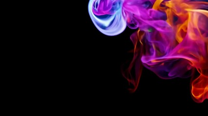 Colored smoke dancing in the air during a night celebration in an open field event