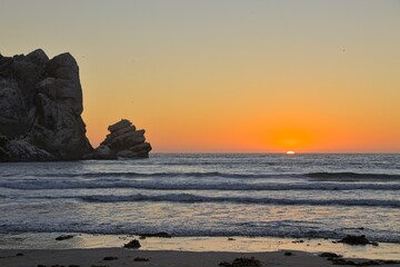The sun sets over the Pacific in Morro Bay, California