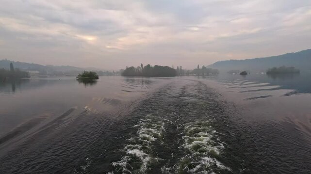 Footage of the red cruse on lake Windermere, Sailing from Bowness to Ambleside. Shot on a misty fogy sunlit day in winter