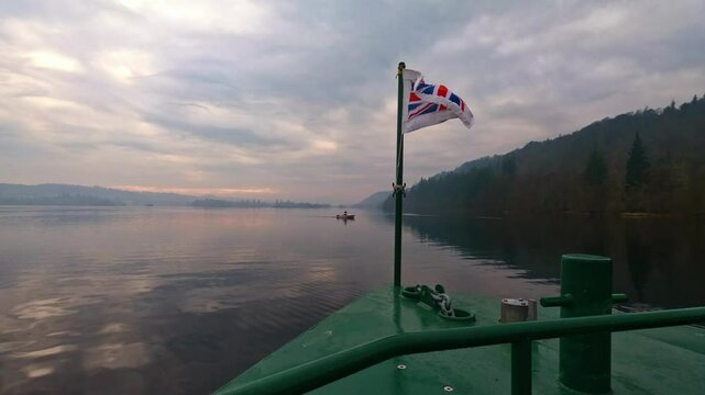Flag flying on the Lake Windermere Cruise Ship on a foggy, misty morning.