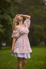 A Beautiful and Elegant Young Woman in a Lovely Summer Dress Posing Gracefully Outdoors