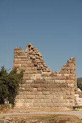 Fototapeta premium Travel, history and building in Greece as temple, structure and ancient architecture at destination. Landmark, monument and city wall with tourism, culture and stone for discovery, adventure and site