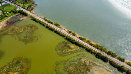 Aerial shot Of a road by the ocean