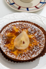 Homemade baked pear cake with caramel almond custard close up, traditional sweets of Perigord, Dordogne, France