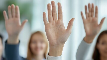A group of people are raising their hands in the air