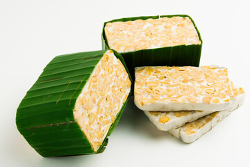 Isolate tempeh wrapped on green banana leaf